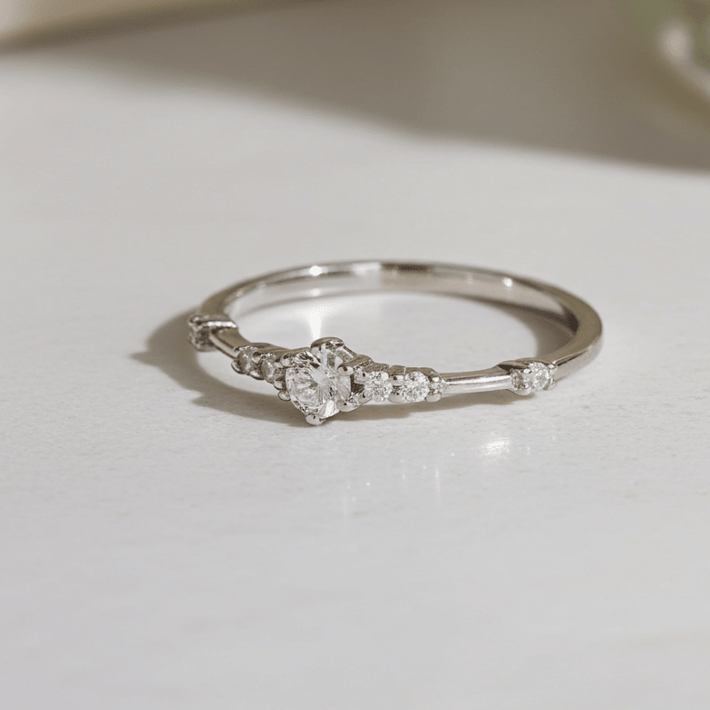 Silver ring with small cubic zirconias on a light surface