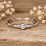 sterling Silver ring with a cubic zirconias on a wooden surface with dried flowers