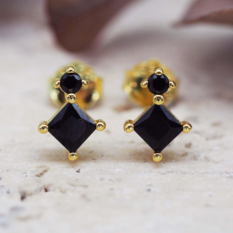 dainty gold earrings with black crystals