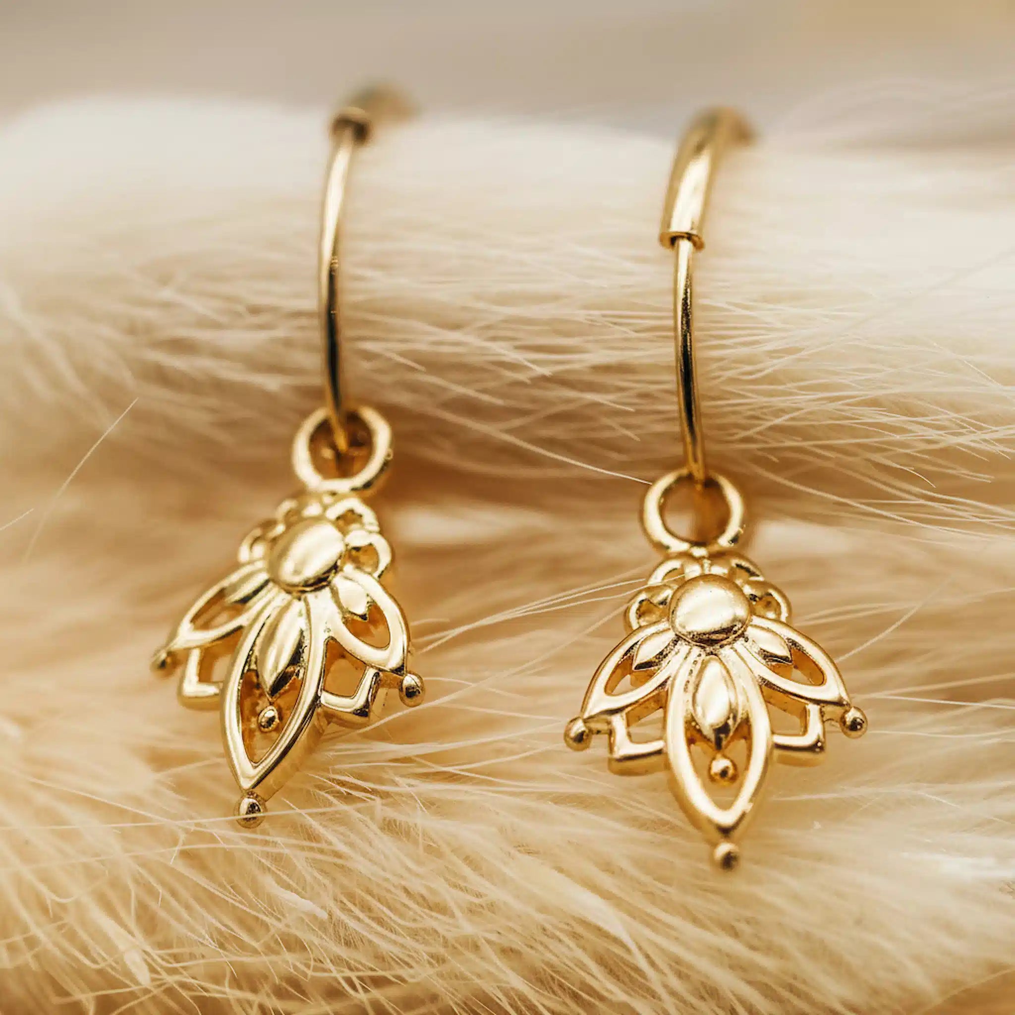 dainty gold hoop earrings with lotus flower charm pendants 