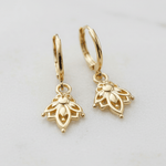 Pair of gold hoop earrings with lotus flower pendants