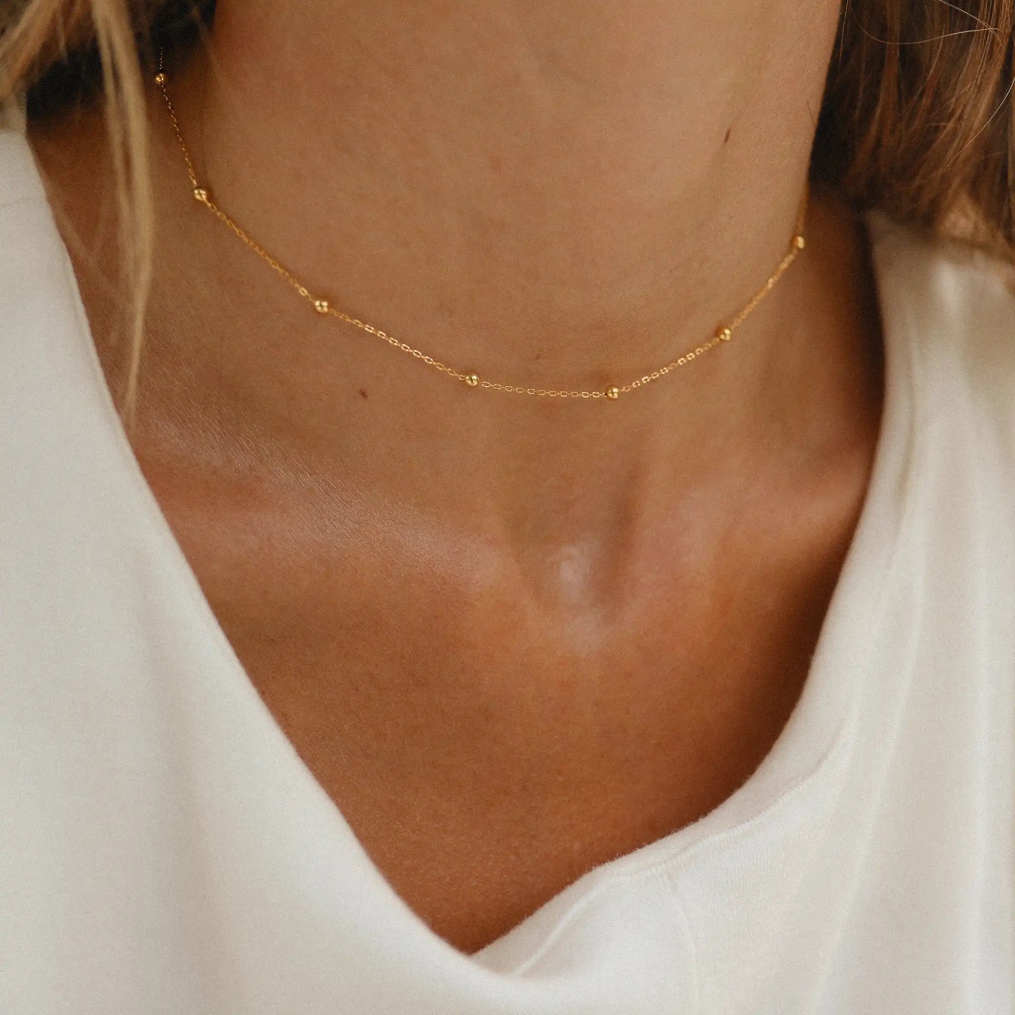woman wearing dainty gold necklace by indie and harper Australia 