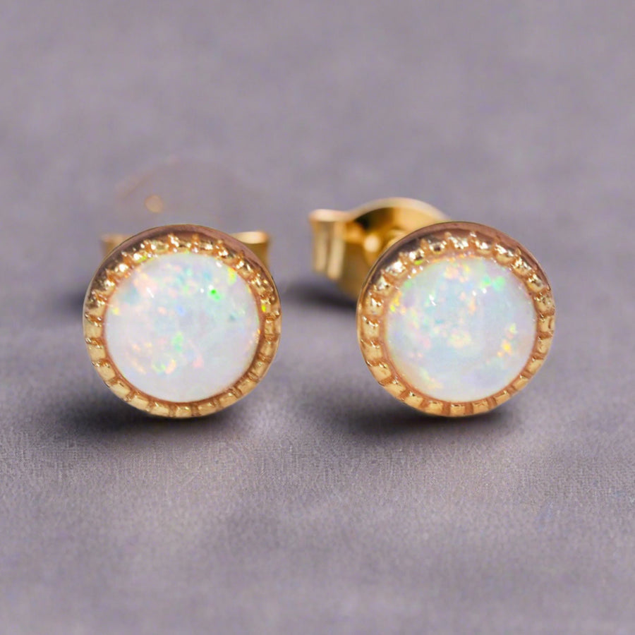 dainty gold earrings with rainbow opals