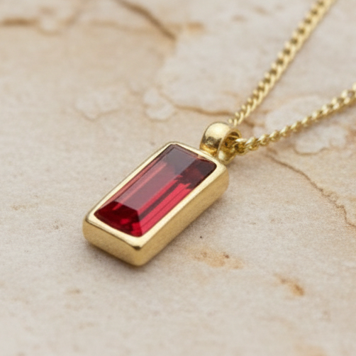 Dainty gold necklace with ruby red faceted pendant 