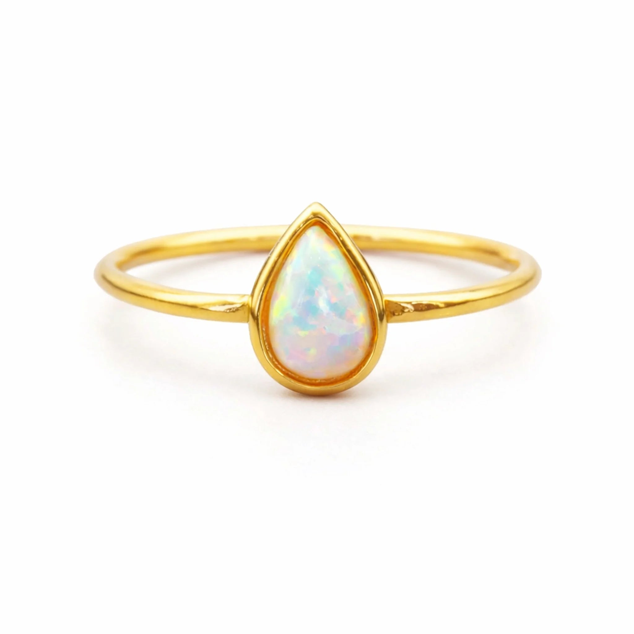 Gold ring with a teardrop-shaped opal stone on a white background
