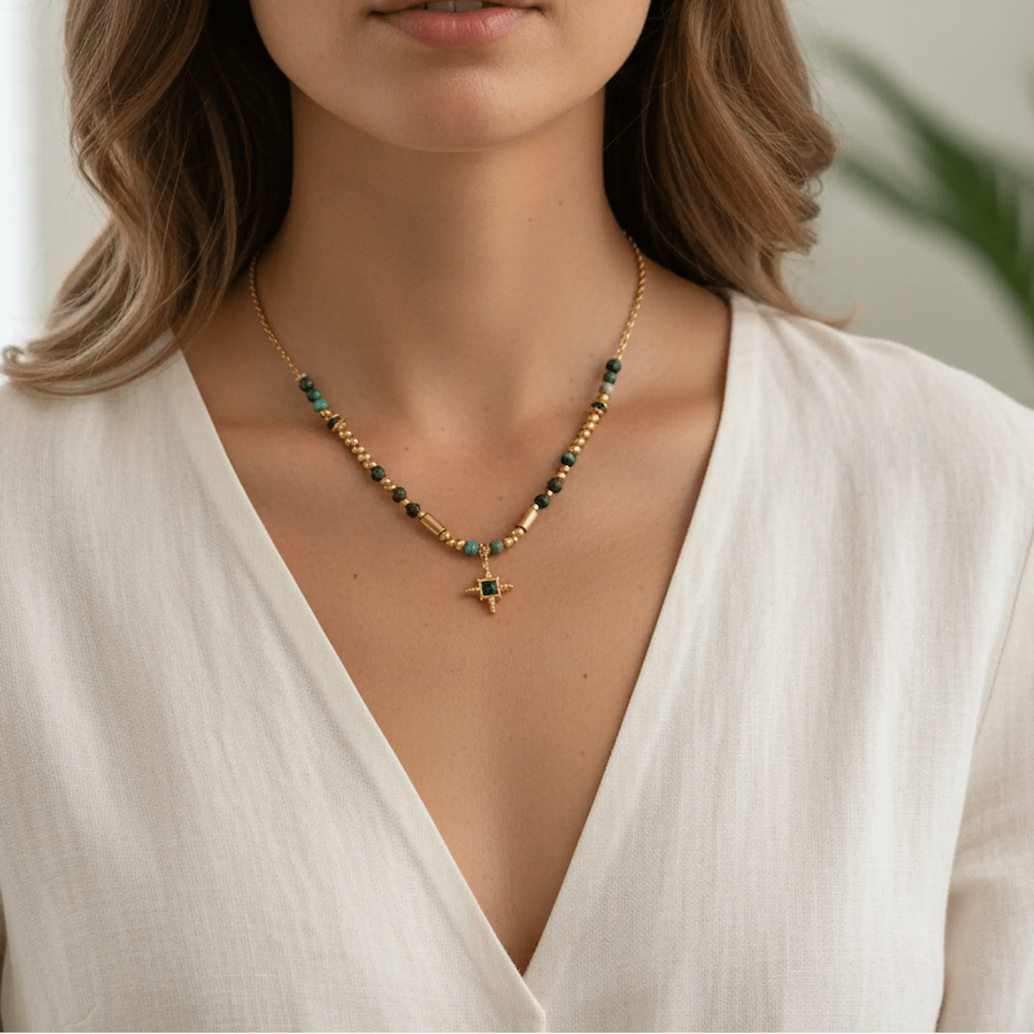 Gold Turquoise Beaded Necklace with green and gold accents worn by a model in a white top.
