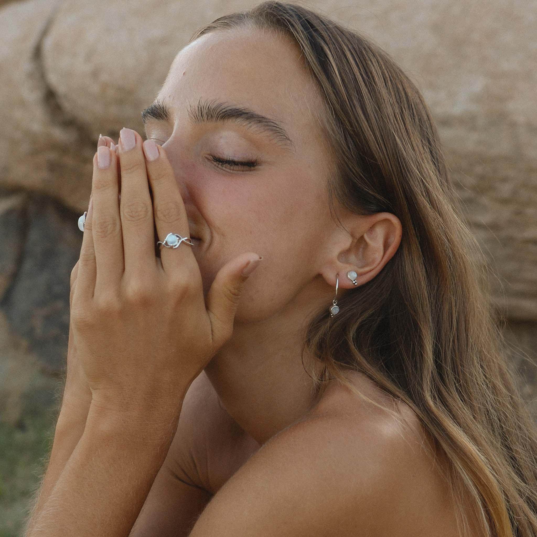 Dainty Moonstone earrings and moonstone ring being worn - indie and harper australia