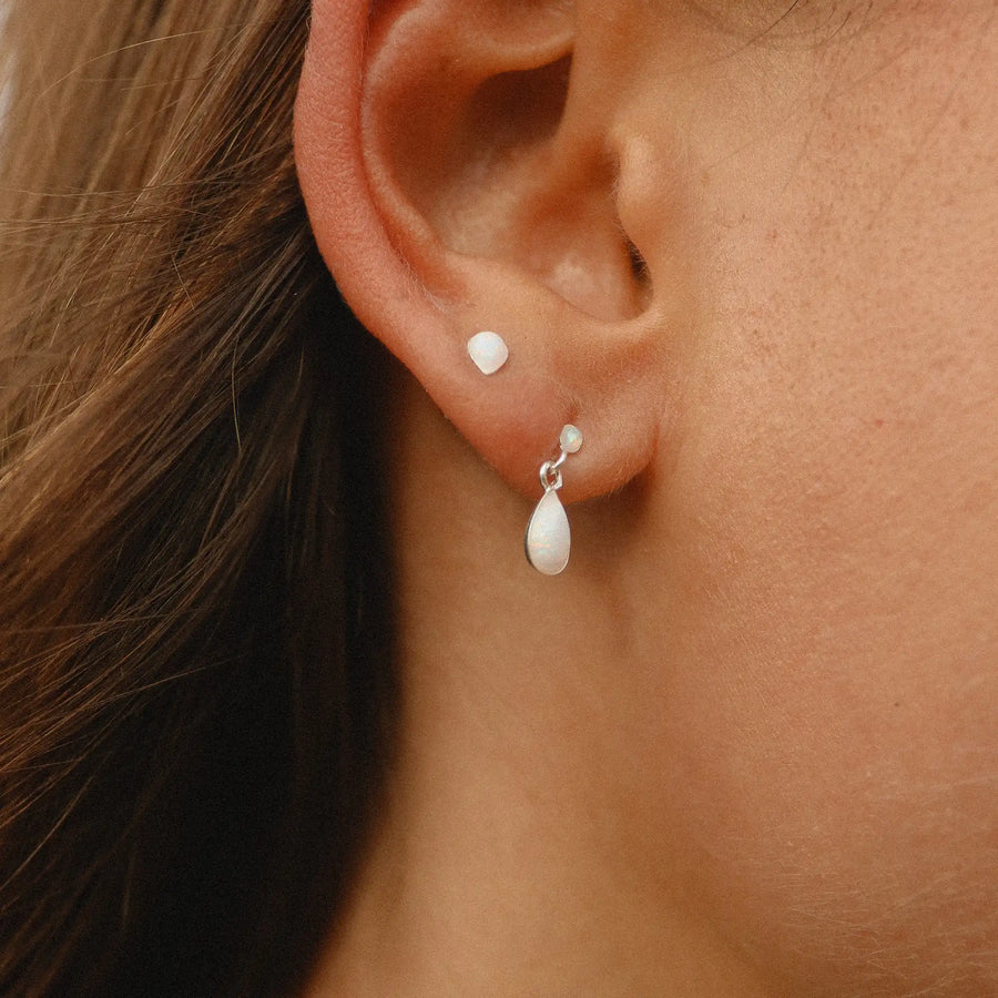 woman wearing teardrop shaped opal earring and small drop opal earring - opal jewellery