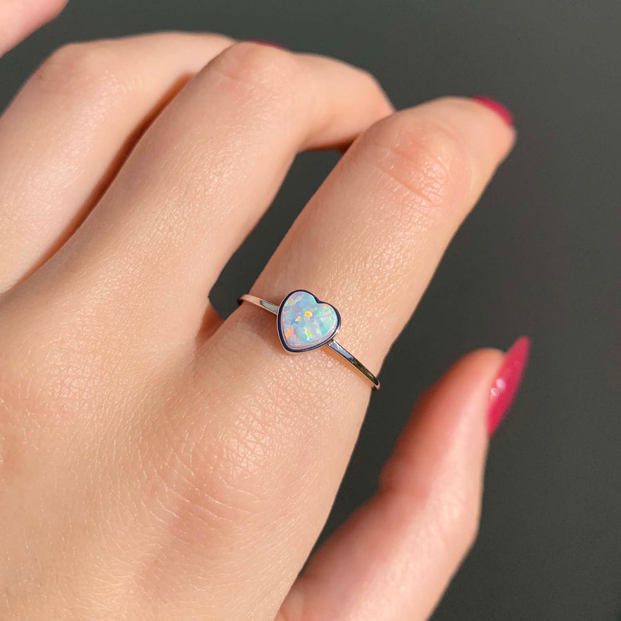 dainty opal heart ring - women's opal jewellery - sterling silver ring with white synthetic opal in natural sunlight - boho jewellery by indie and harper