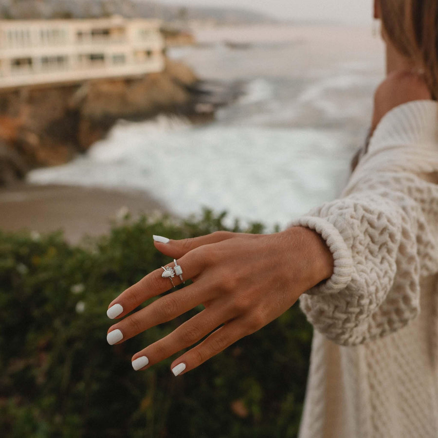 woman wearing white opal rings 