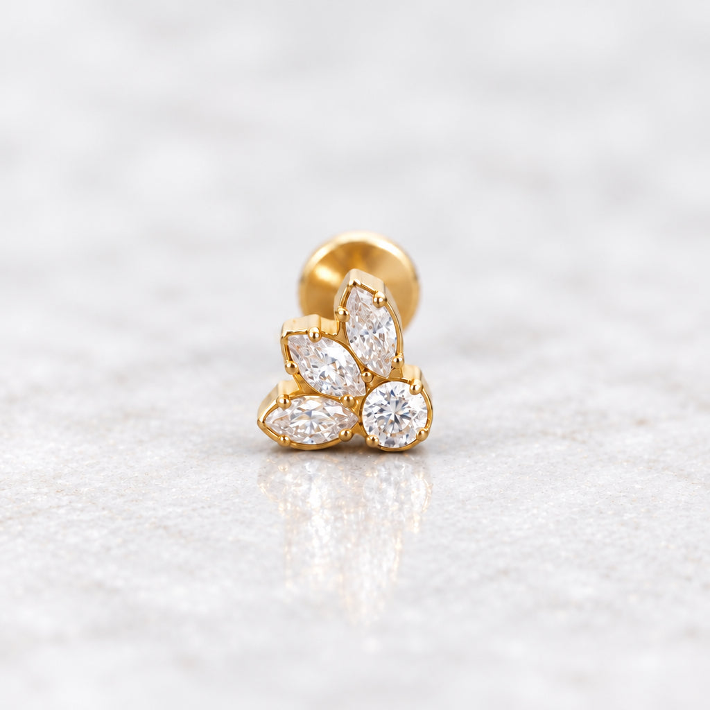 Gold petal flat back earring with cubic zirconia on a grey surface