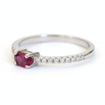 Silver ring with a red garnet gemstone and small cubic zirconias 