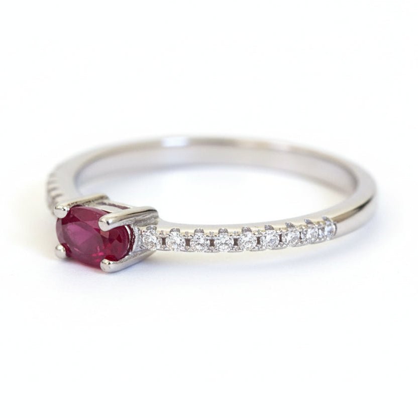 Silver ring with a red garnet gemstone and small cubic zirconias 