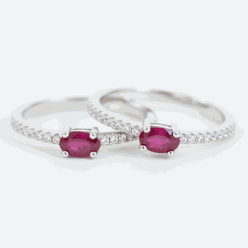 Two silver rings with red gemstones on a white background