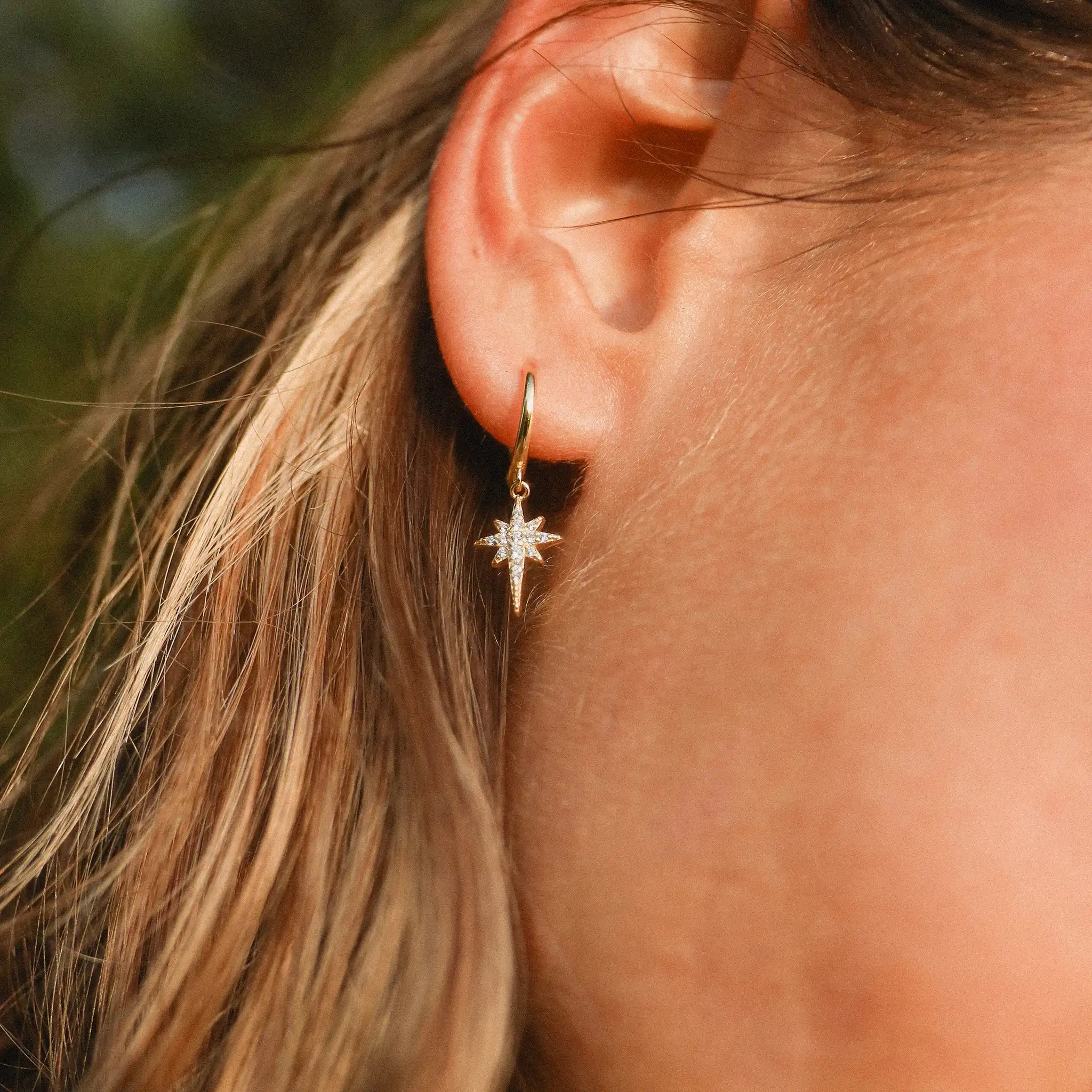 gold Dainty shooting star hoop Earrings being worn by indie and Harper australia 