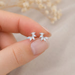 fingers holding sterling silver stud earrings with marquise shaped czs