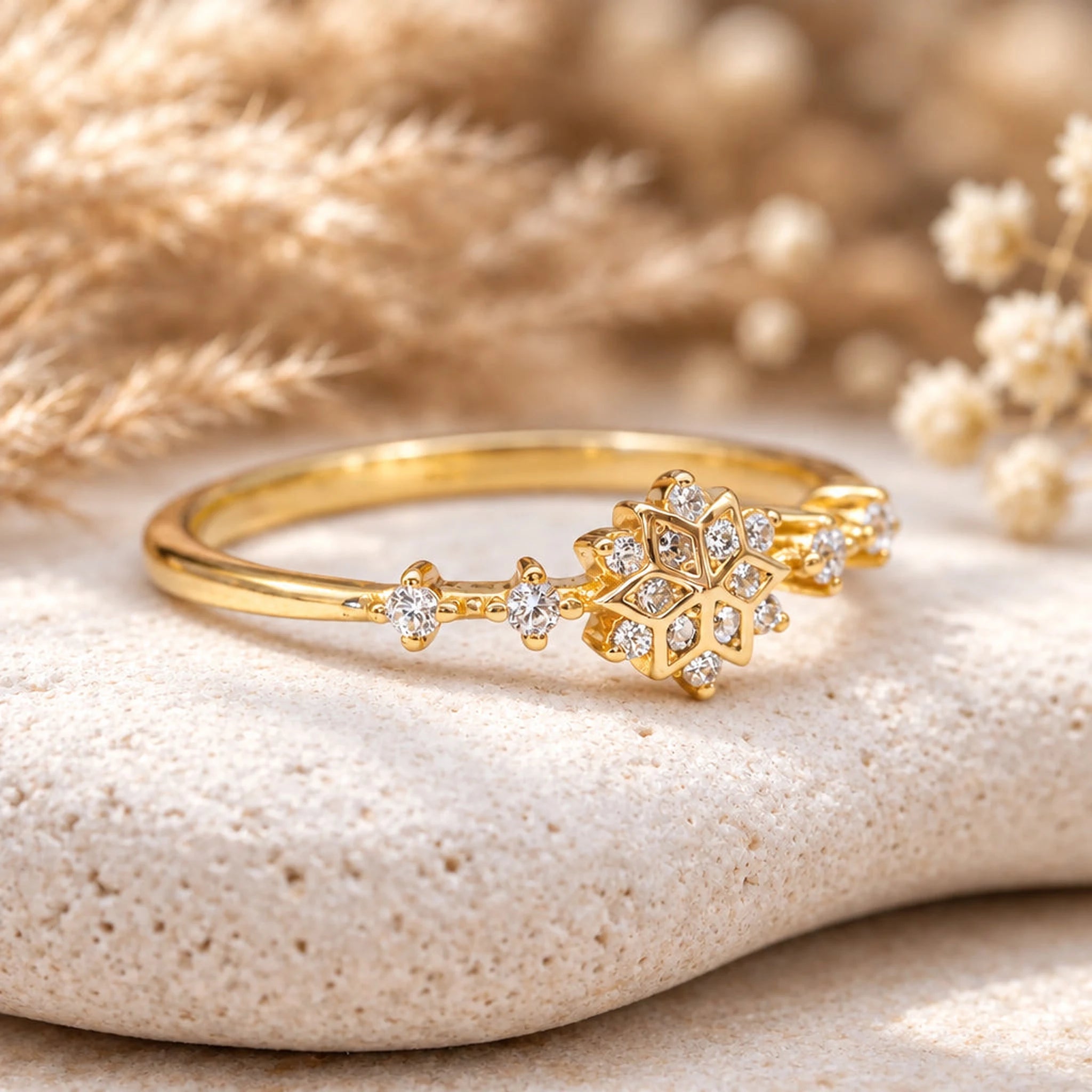 Gold snowflake ring with clear stones, angled view