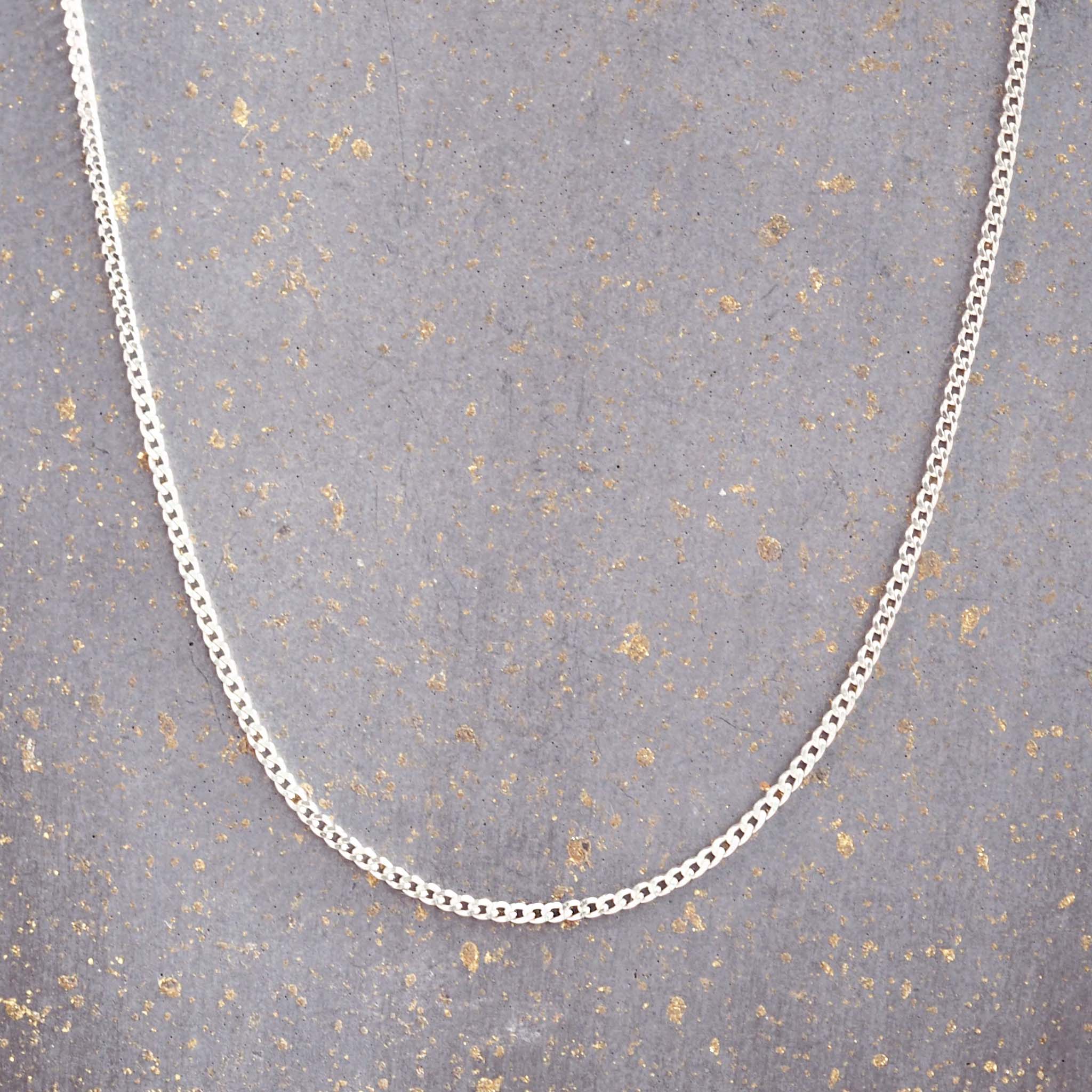 sterling silver chain necklace on a grey background