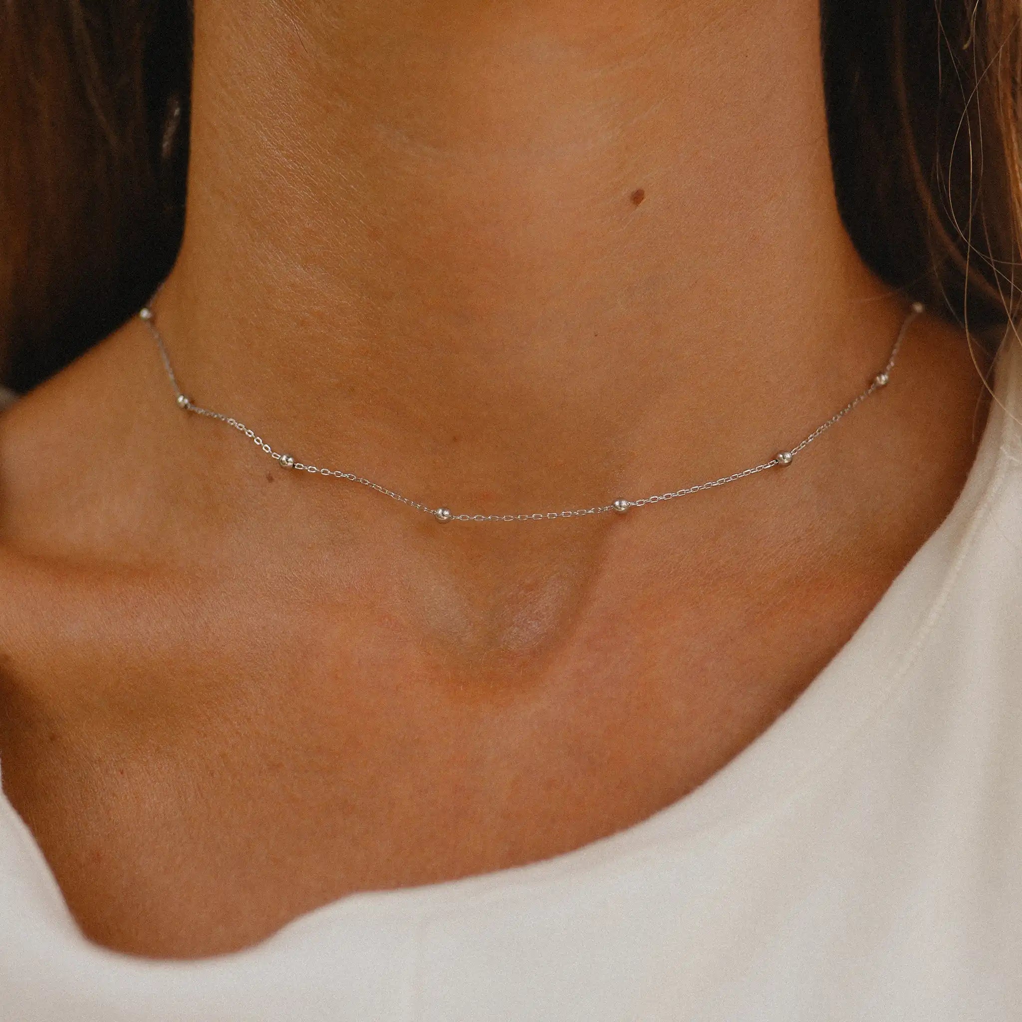 woman wearing dainty silver necklace by indie and harper Australia 