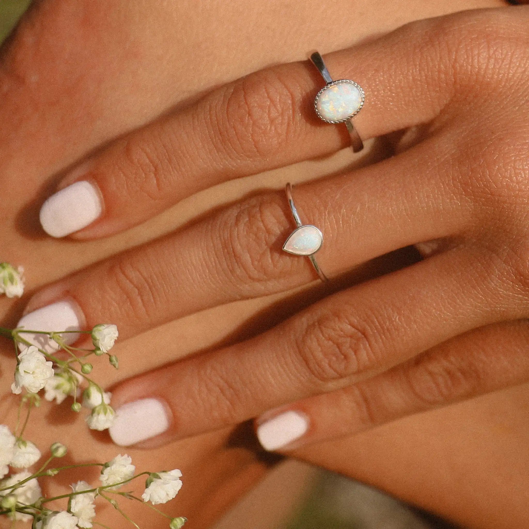 Woman wearing sterling silver dainty white Opal Rings - opal jewellery by australian jewellery brands indie and Harper