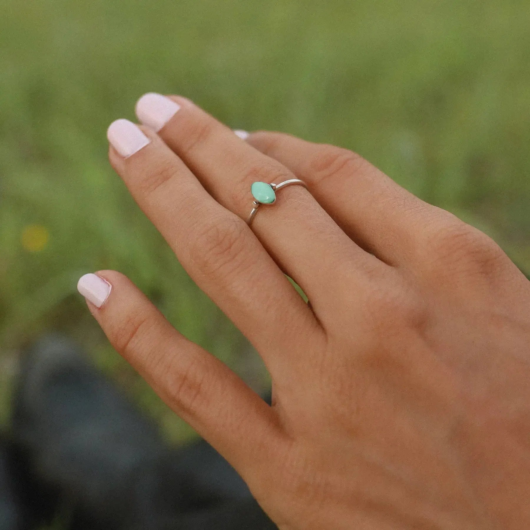 Woman wearing sterling silver dainty minimalist turquoise ring 