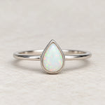 Dainty White Opal Teardrop Ring in polished sterling silver, front view showing the pear-shaped lab-grown opal.