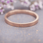 rose gold band stacker ring on a grey surface, as one of the three rings in the rose gold multi ring set