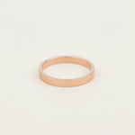 rose gold band stacker ring on a grey surface
