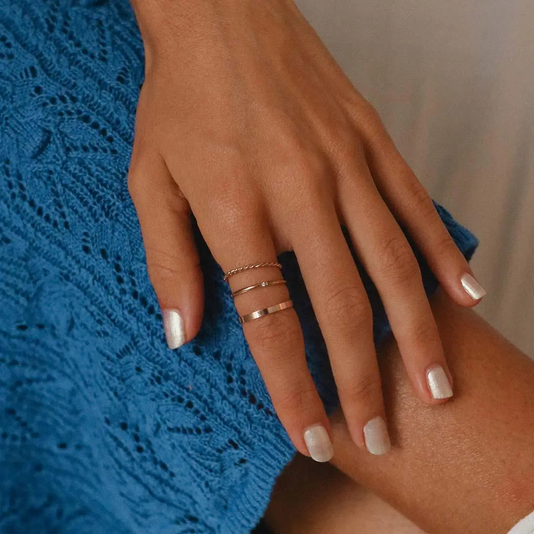 womans hand wearing rose gold rings - rose gold waterproof jewellery australia by  indie and harper