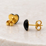 Black epoxy heart stud earrings in gold PVD stainless steel, back view