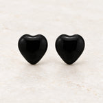 Black epoxy heart stud earrings in gold PVD stainless steel, front view