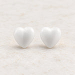 White epoxy heart stud earrings in gold PVD stainless steel, front view
