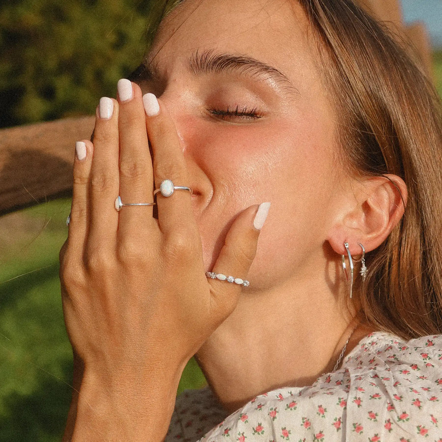 woman wearing three sterling silver rings with opals
