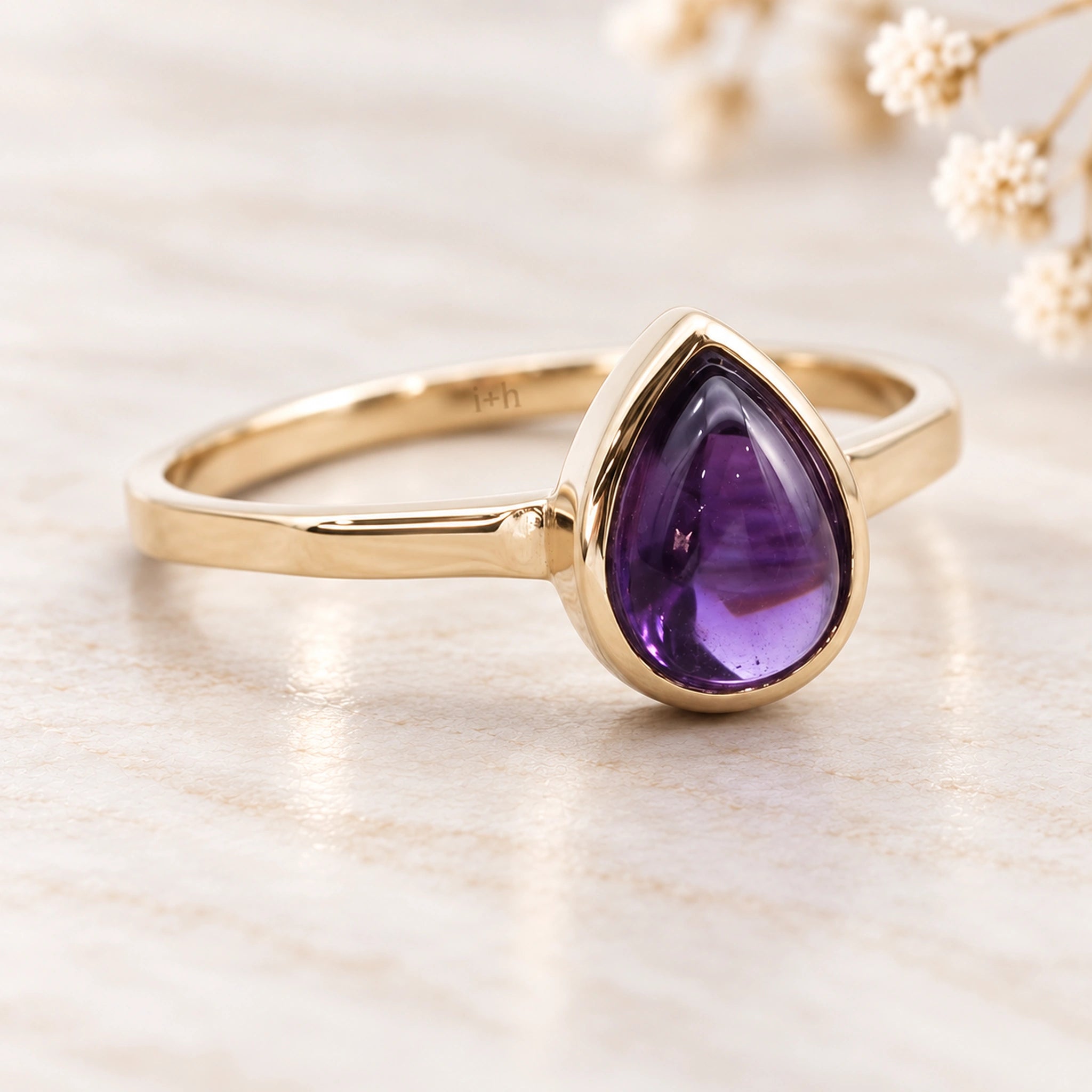 Angled view of soft 9k gold February natural amethyst birthstone ring