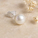Single Sterling Silver Classic 7mm Natural Freshwater Pearl Stud Earring on a light background.