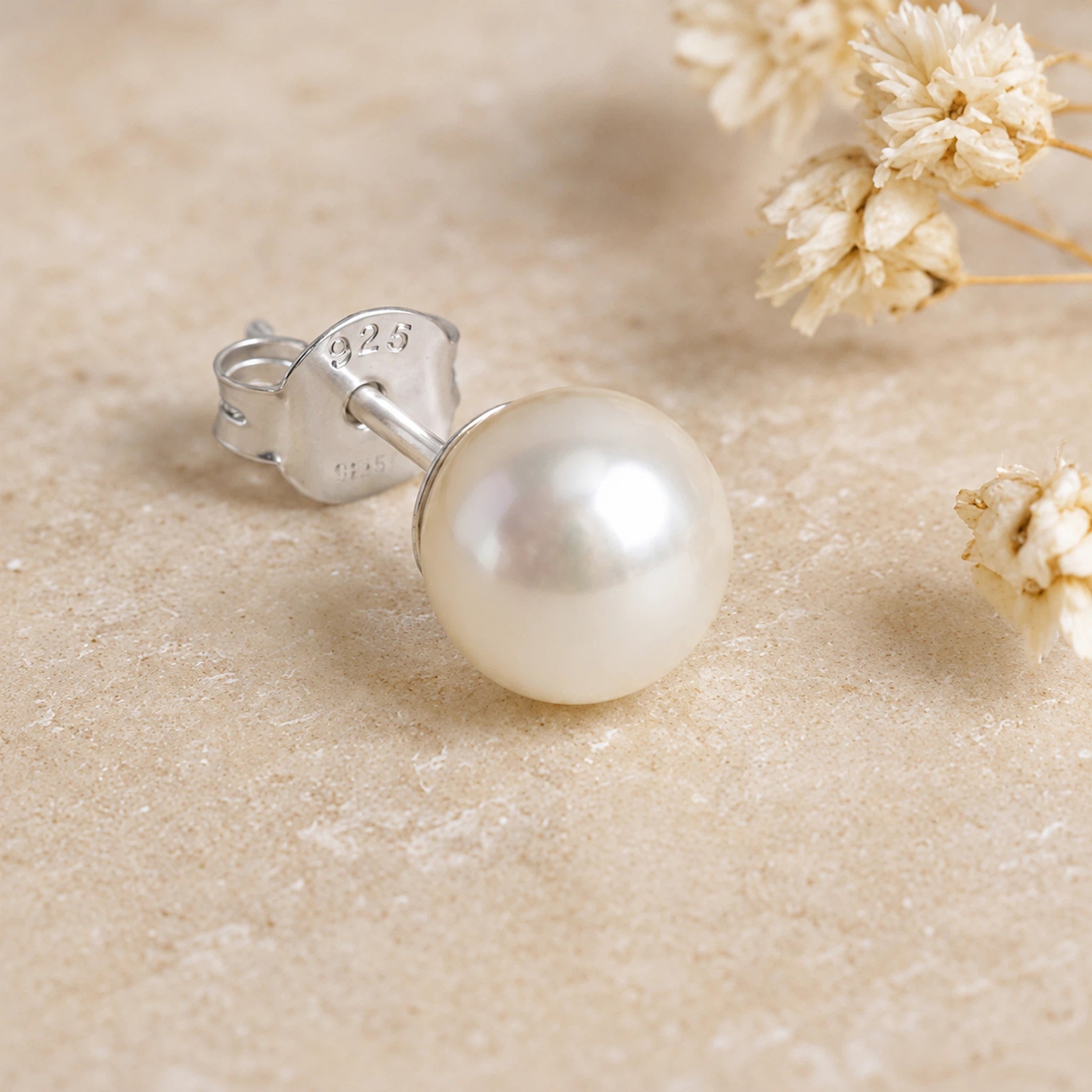 Single Sterling Silver Classic 7mm Natural Freshwater Pearl Stud Earring on a light background.