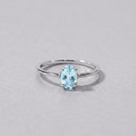 Sterling silver blue topaz ring, front view of the oval pale blue topaz