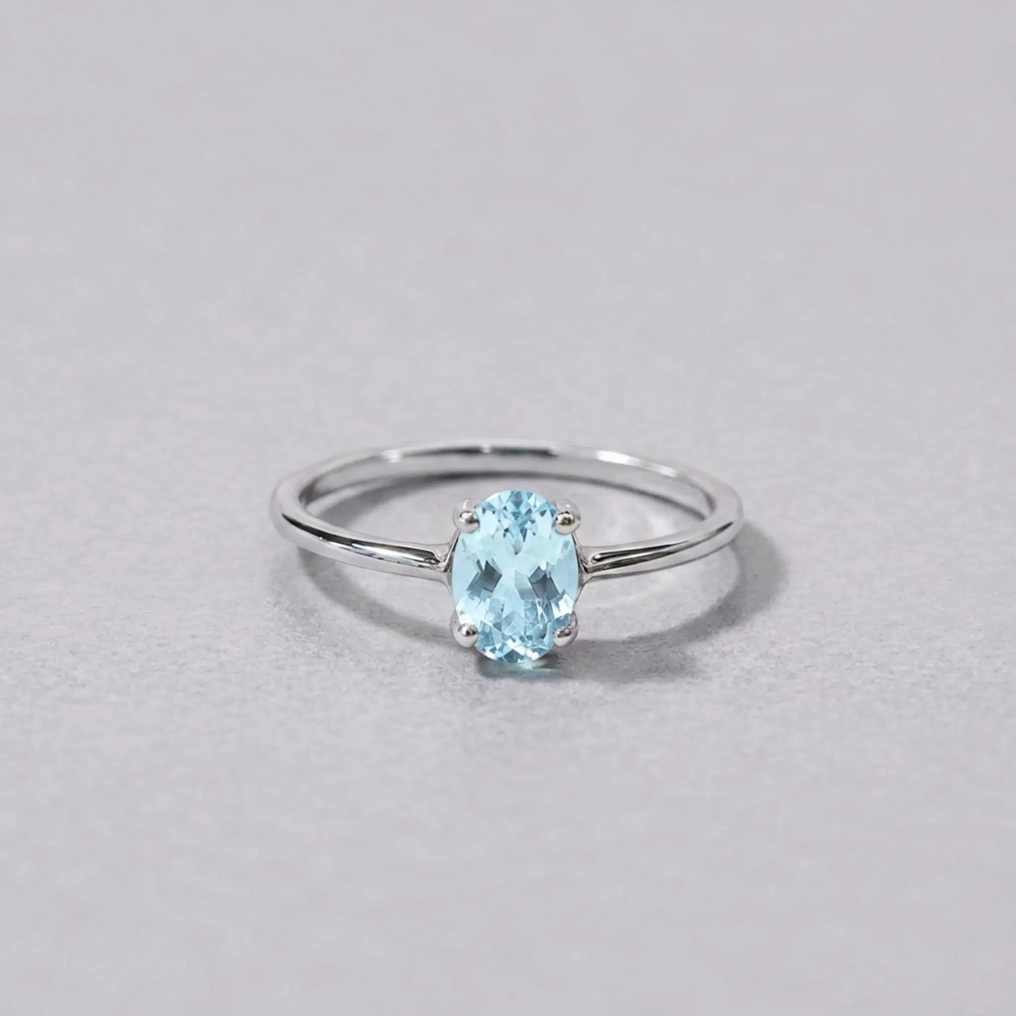 Sterling silver blue topaz ring, front view of the oval pale blue topaz