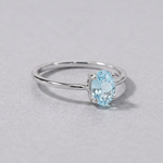 Sterling silver blue topaz ring with a faceted oval pale blue topaz, front view