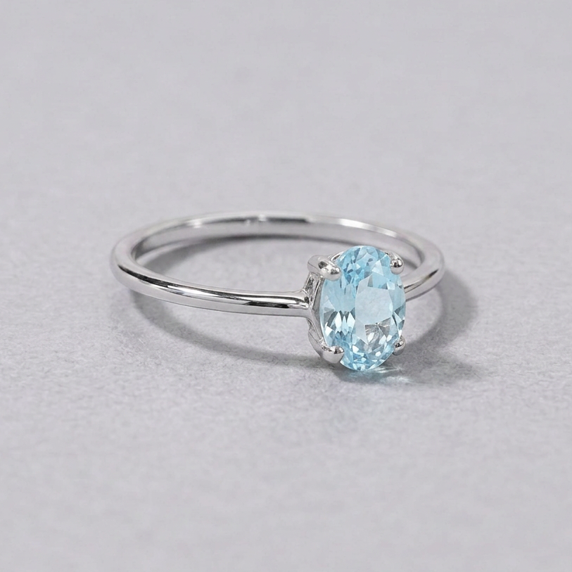 Sterling silver blue topaz ring with a faceted oval pale blue topaz, front view