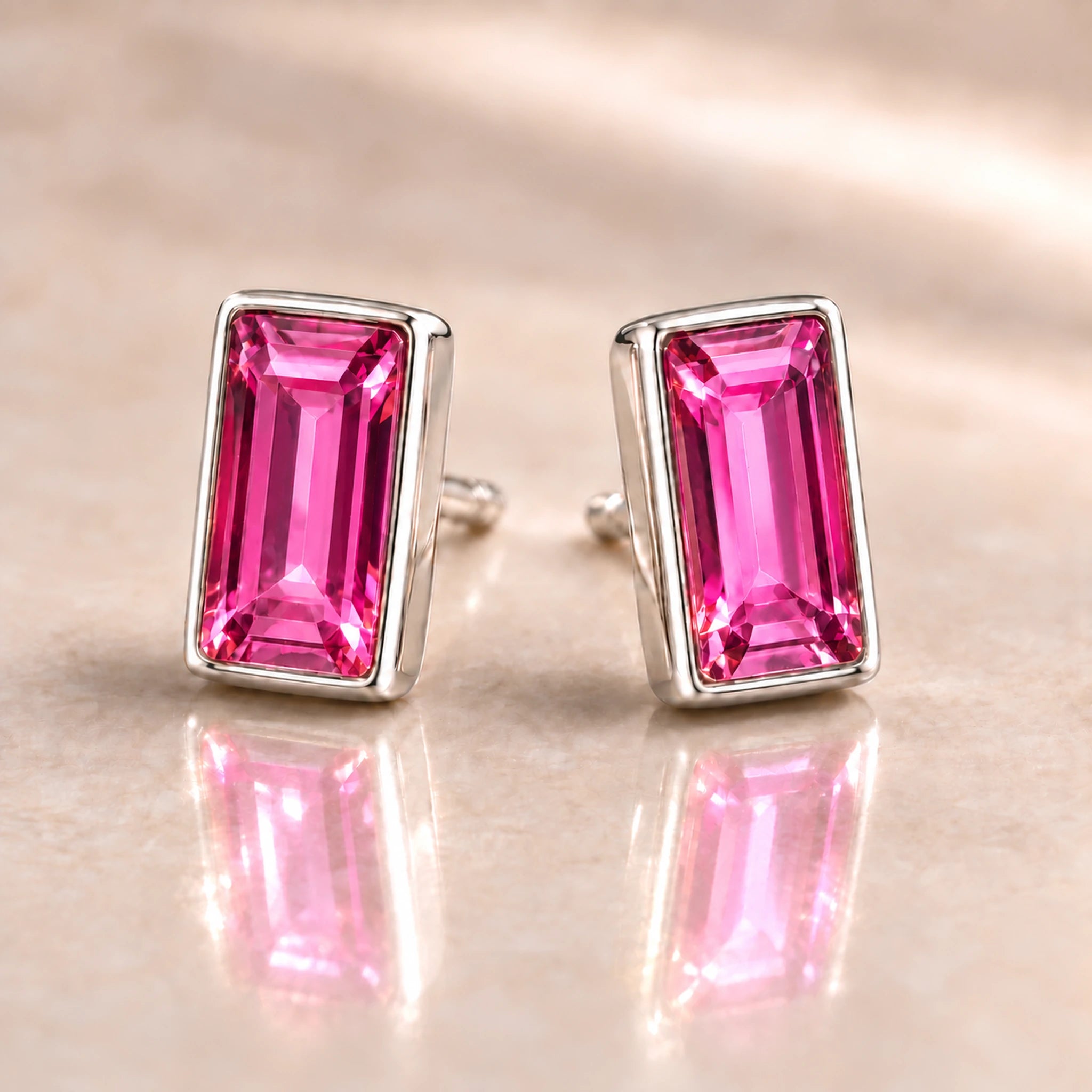 Fuchsia Austrian crystal baguette stud earrings in polished sterling silver, angled view