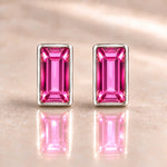 Fuchsia Austrian crystal baguette stud earrings in polished sterling silver, front view