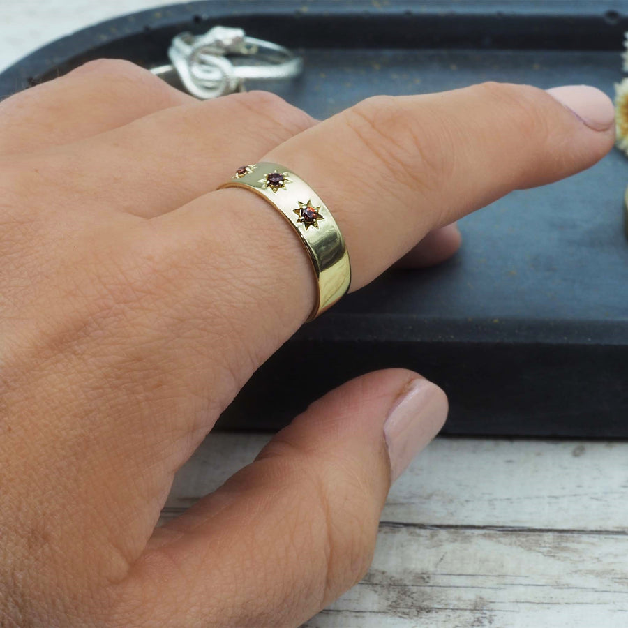 gold garnet ring being worn - gold garnet jewellery