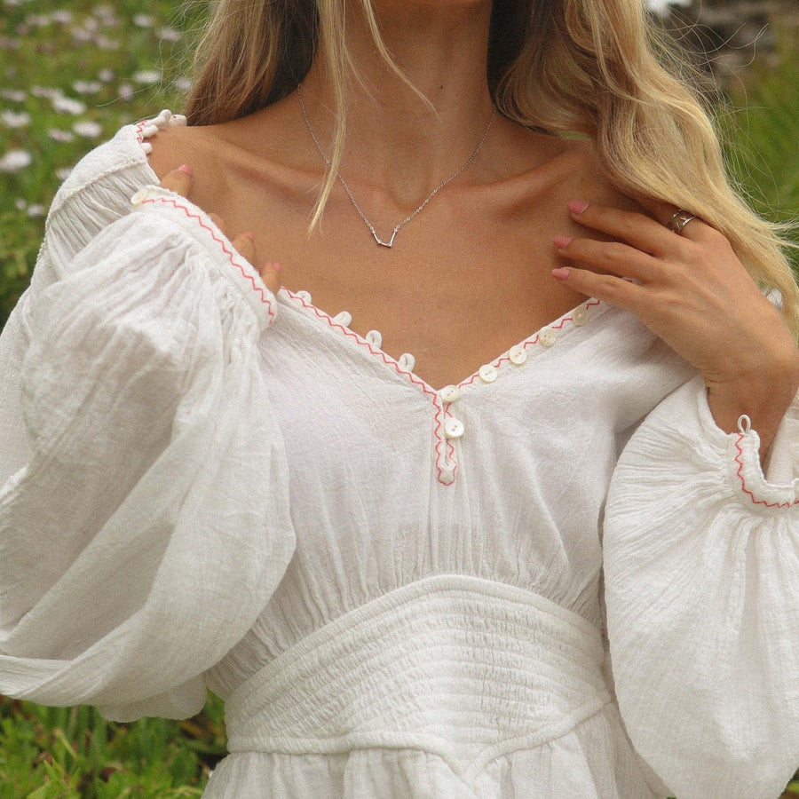 woman with white flowly necklace wearing dainty silver necklace  - australian jewellery brand