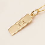 gemini zodiac necklace in gold plated sterling silver on a white background
