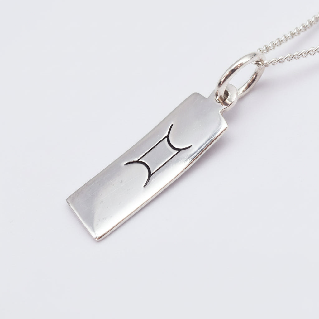 sterling silver gemini zodiac necklace on a white background