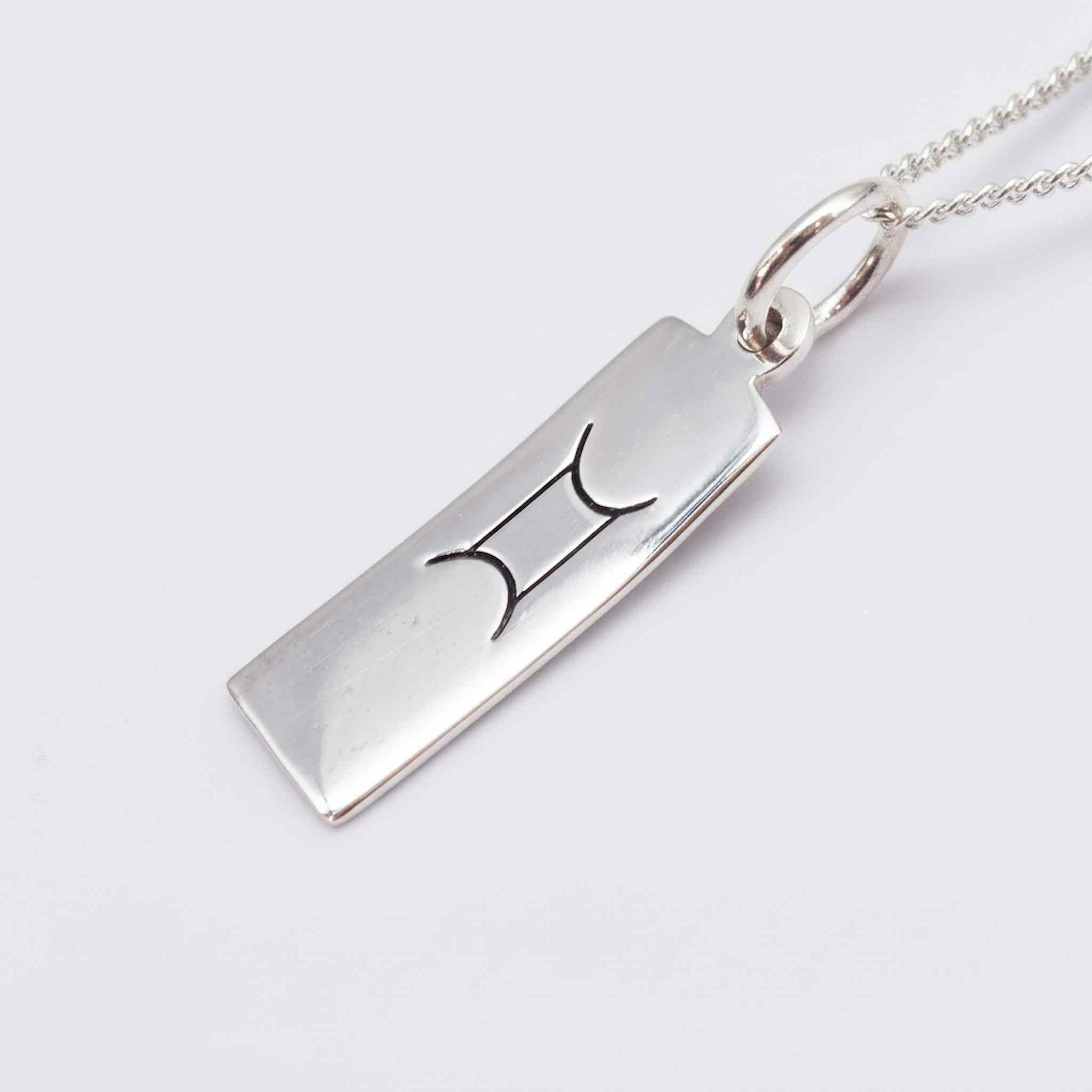 sterling silver gemini zodiac necklace on a white background- meaningful birthday gift