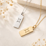 gemini zodiac line glyph pendant necklaces in sterling silver and 9k gold plated sterling silver on a light surface