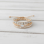 multi wrap boho natural moonstone gemstone beaded bracelet on a white wooden surface