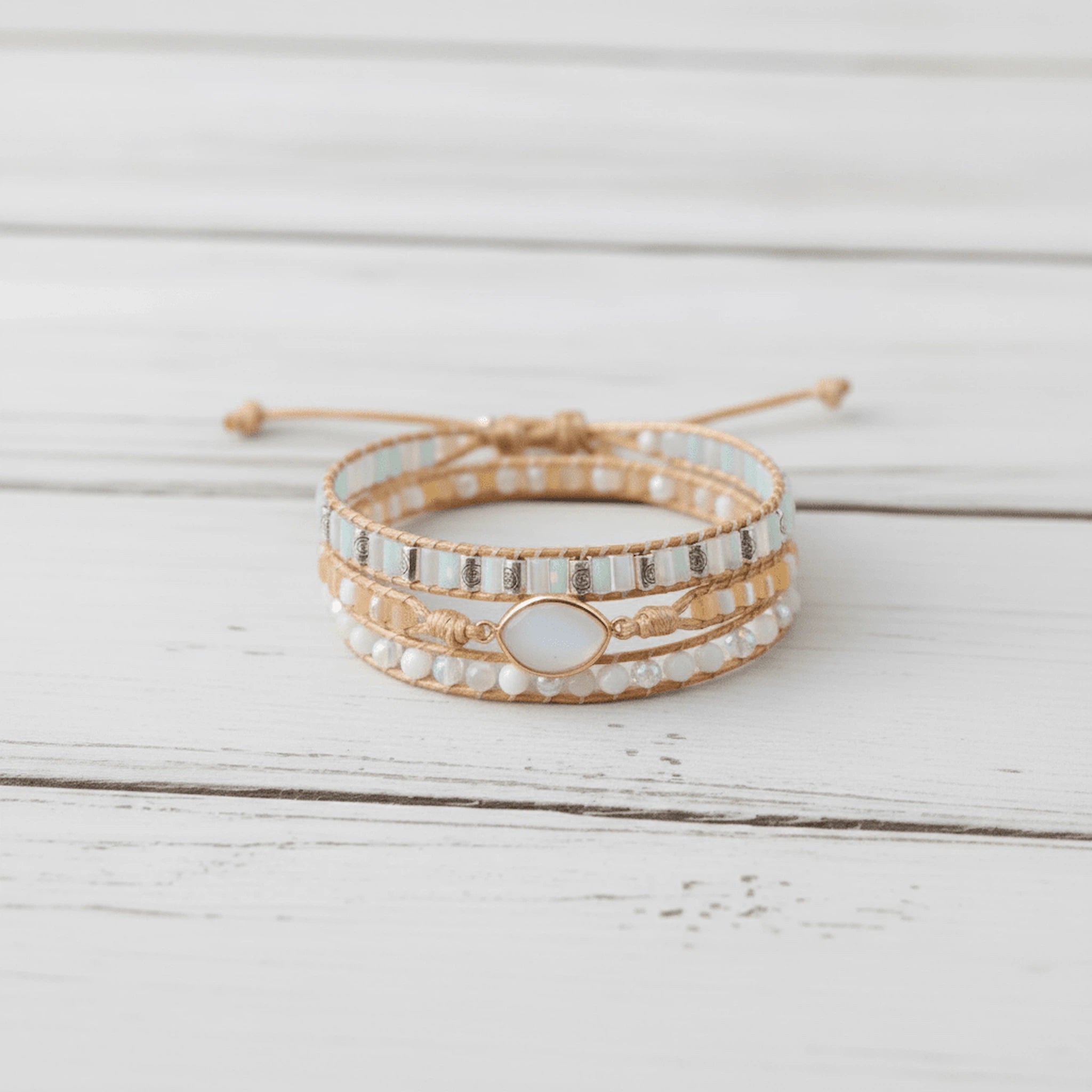 multi wrap boho natural moonstone gemstone beaded bracelet on a white wooden surface